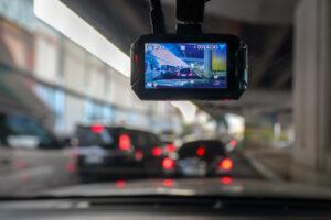 Dash camera mounted inside a vehicle recording traffic ahead, illustrating the use of dashcam footage as evidence in Michigan OWI and traffic-related defense cases