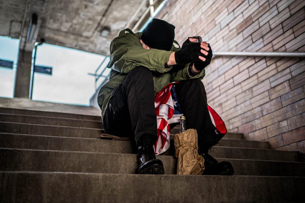 Homeless war veteran sitting on the subway station
